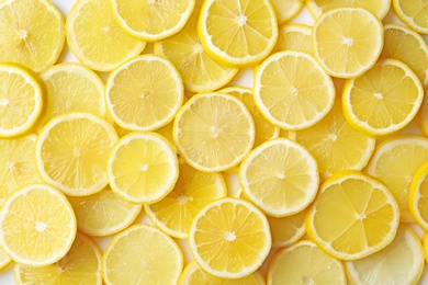 Photo of Many slices of fresh ripe lemons as background