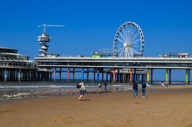 Photo of Hague, Netherlands - May 2, 2022: Beautiful view of beach and Scheveningen Pier with Ferris wheel