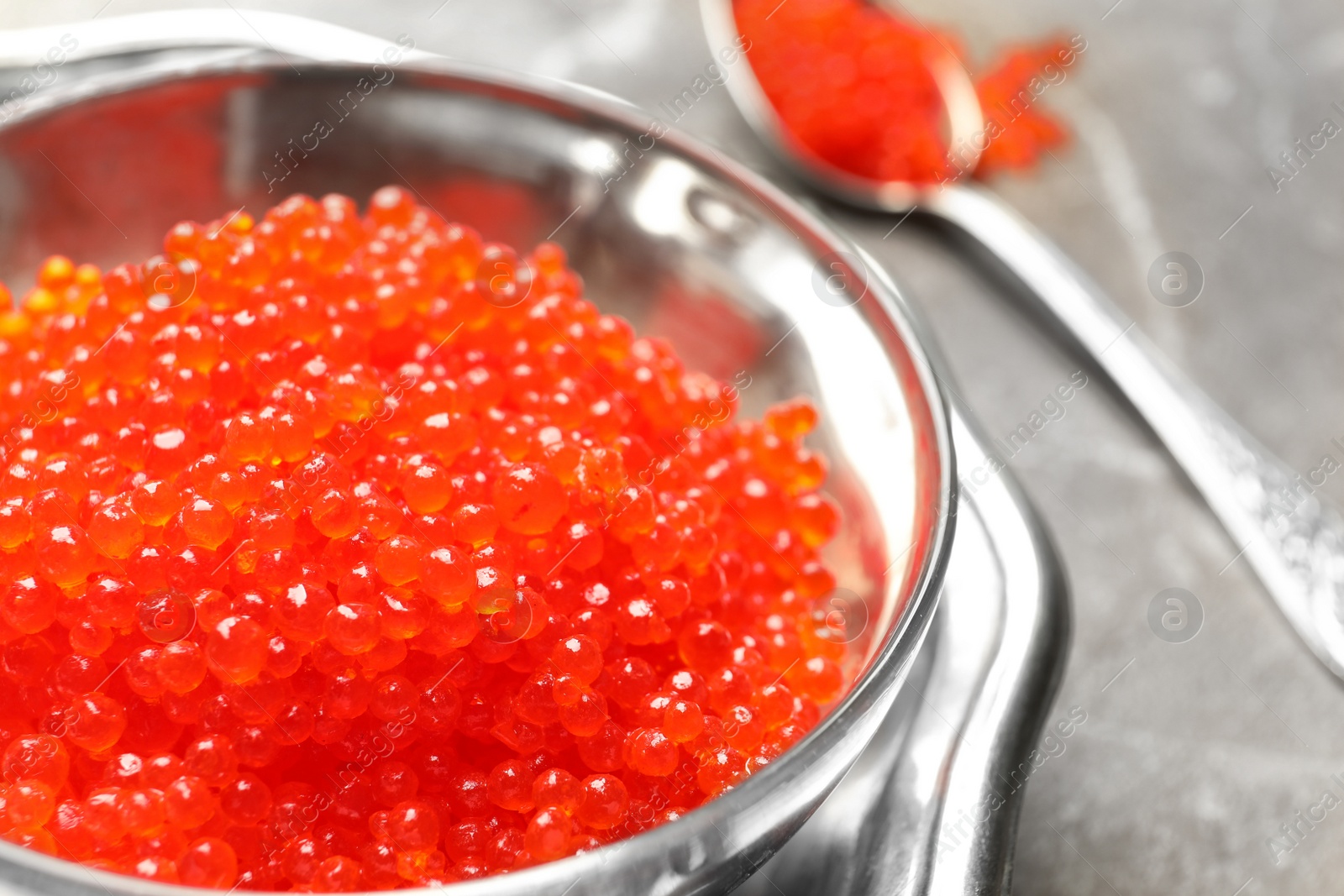 Photo of Bowl with delicious red caviar on table