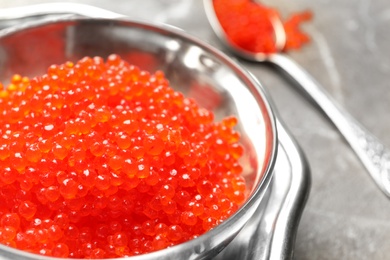 Bowl with delicious red caviar on table