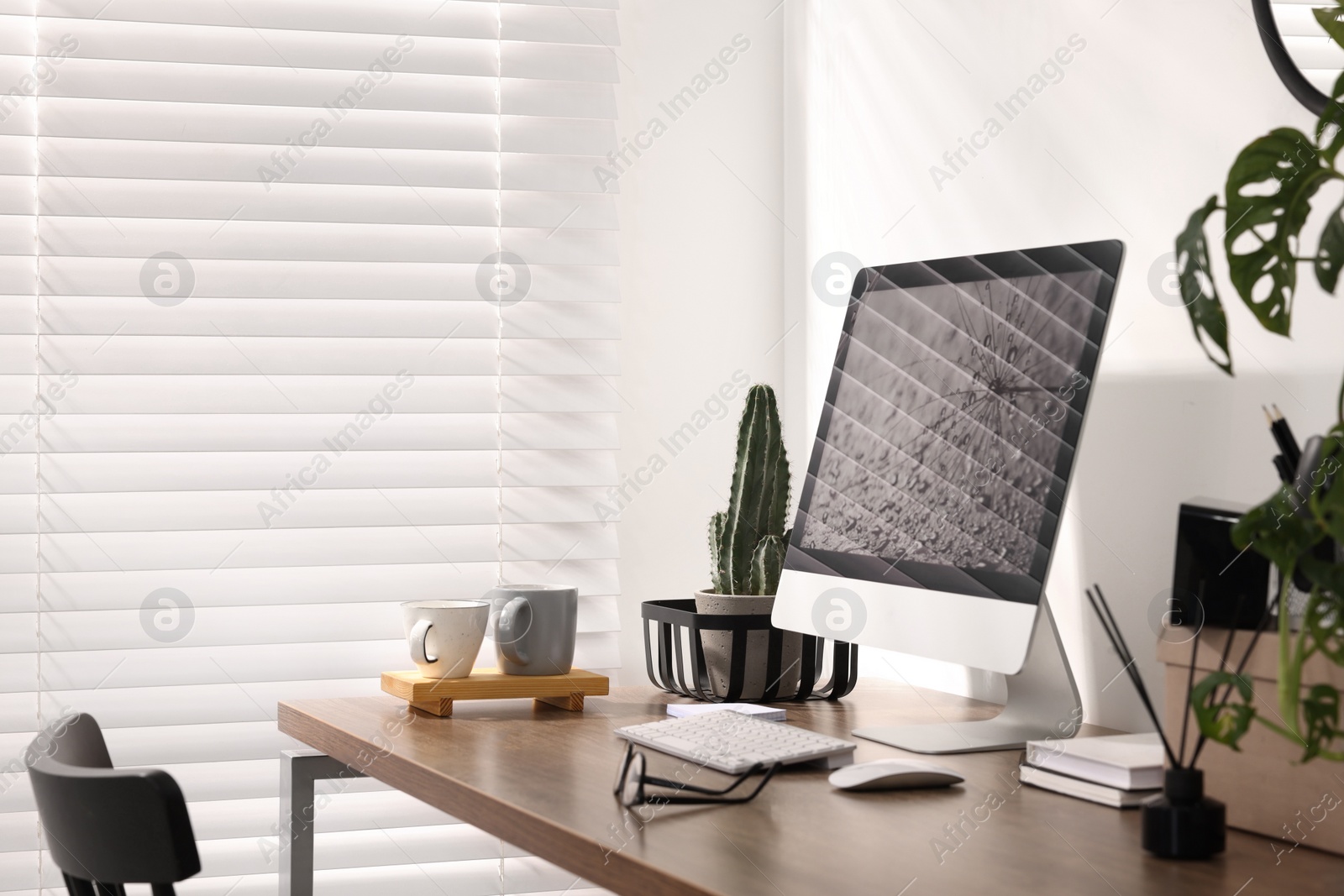 Photo of Cozy workspace with computer on wooden desk at home