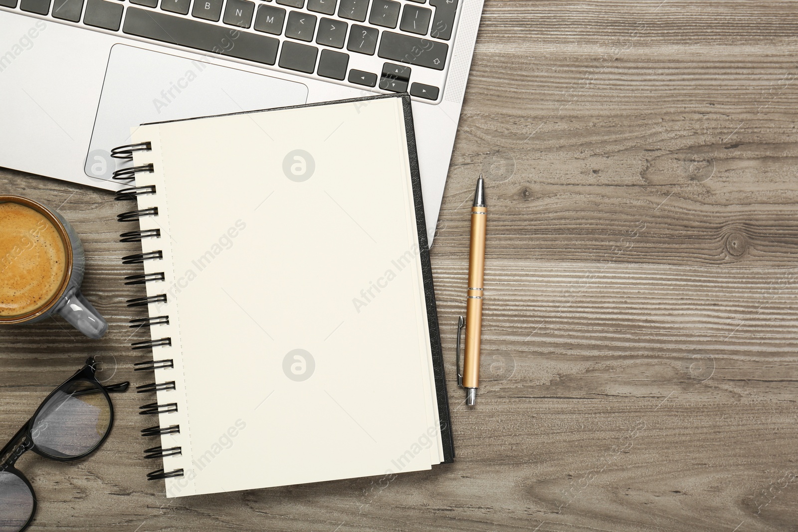 Photo of Flat lay composition with notebook and laptop on wooden table, space for text