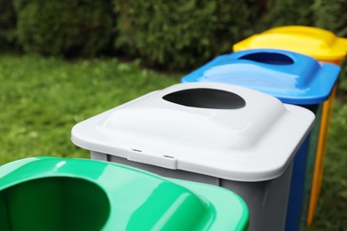 Many color recycling bins outdoors, closeup view