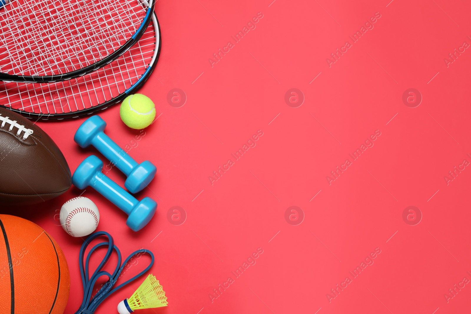 Photo of Set of different sports equipment on red background, flat lay. Space for text