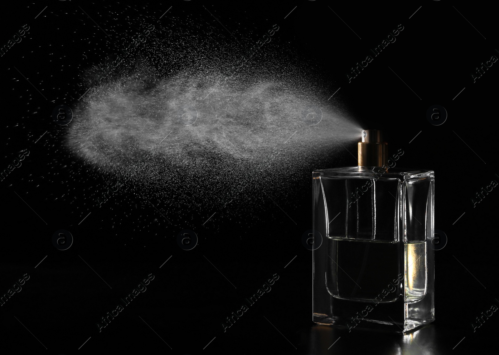 Photo of Woman spraying luxury perfume on black background, closeup. Space for text