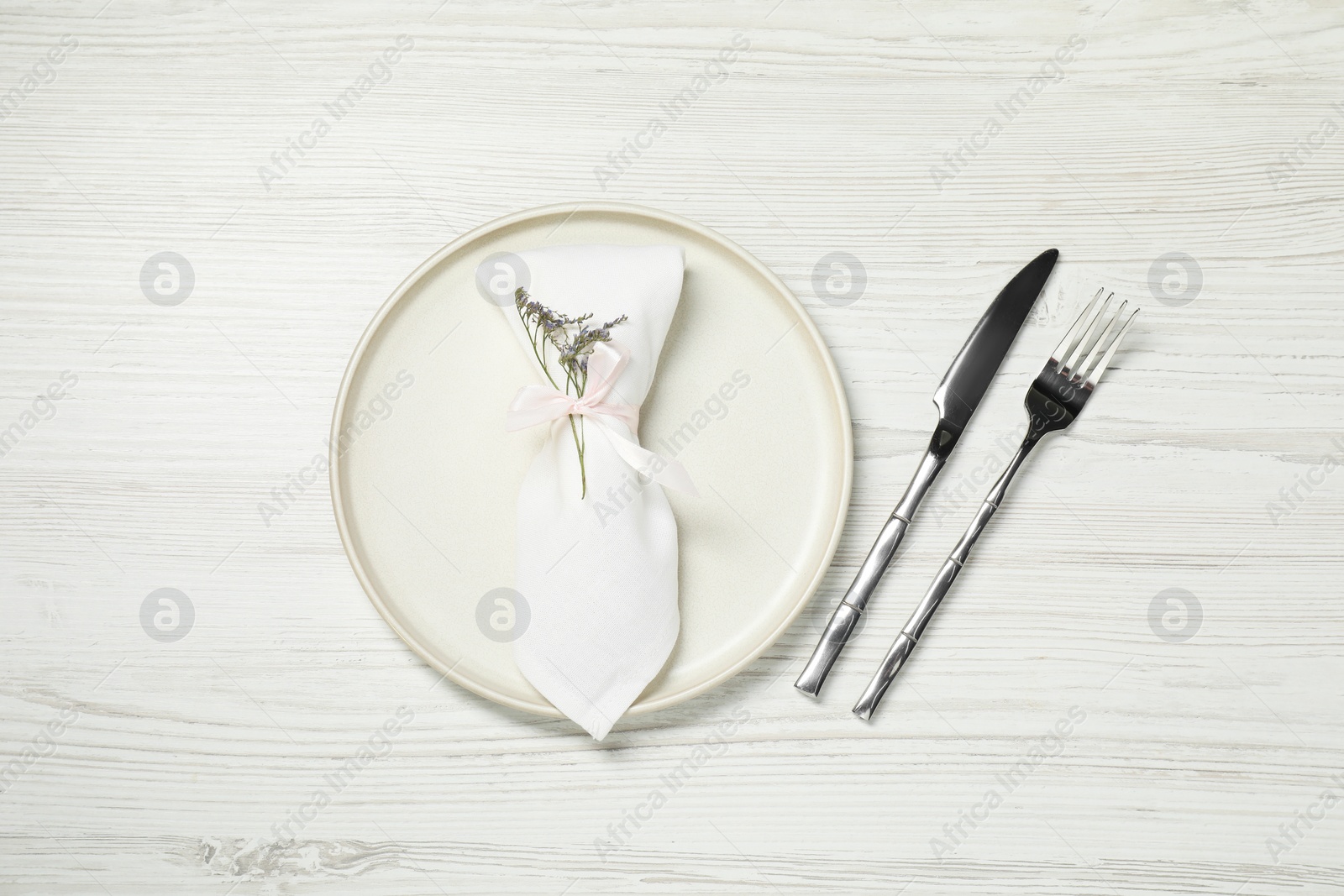 Photo of Stylish setting with elegant cutlery on white wooden table, top view