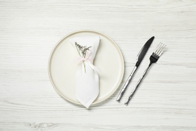 Stylish setting with elegant cutlery on white wooden table, top view