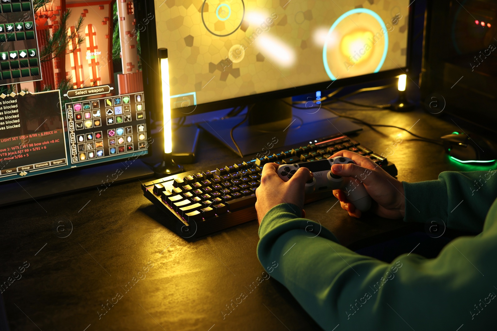 Photo of Man playing video games with controller at table indoors, closeup