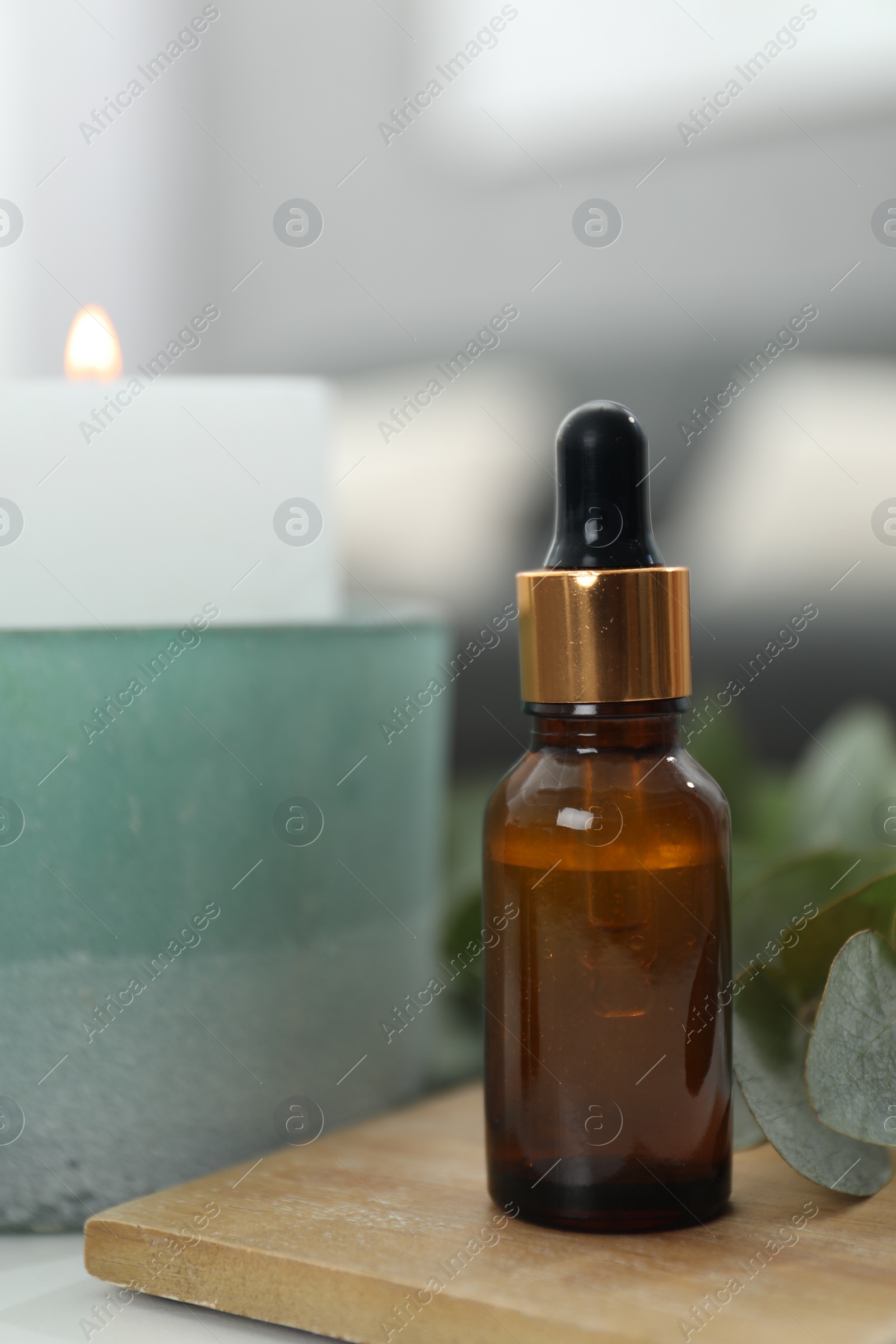 Photo of Aromatherapy. Bottle of essential oil and eucalyptus leaves on table