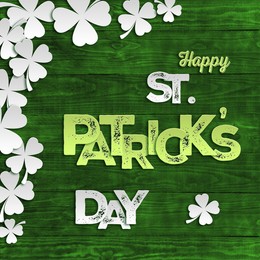 Image of Happy St. Patrick's day card. Decorative clover leaves and text on green wooden background, top view