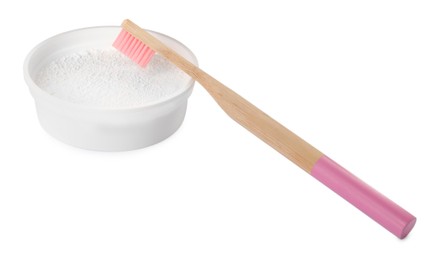 Photo of Bowl of tooth powder and brush on white background