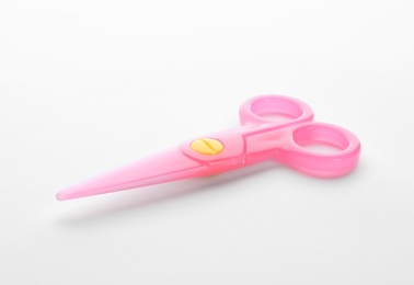 Colorful plastic scissors on white background. School stationery