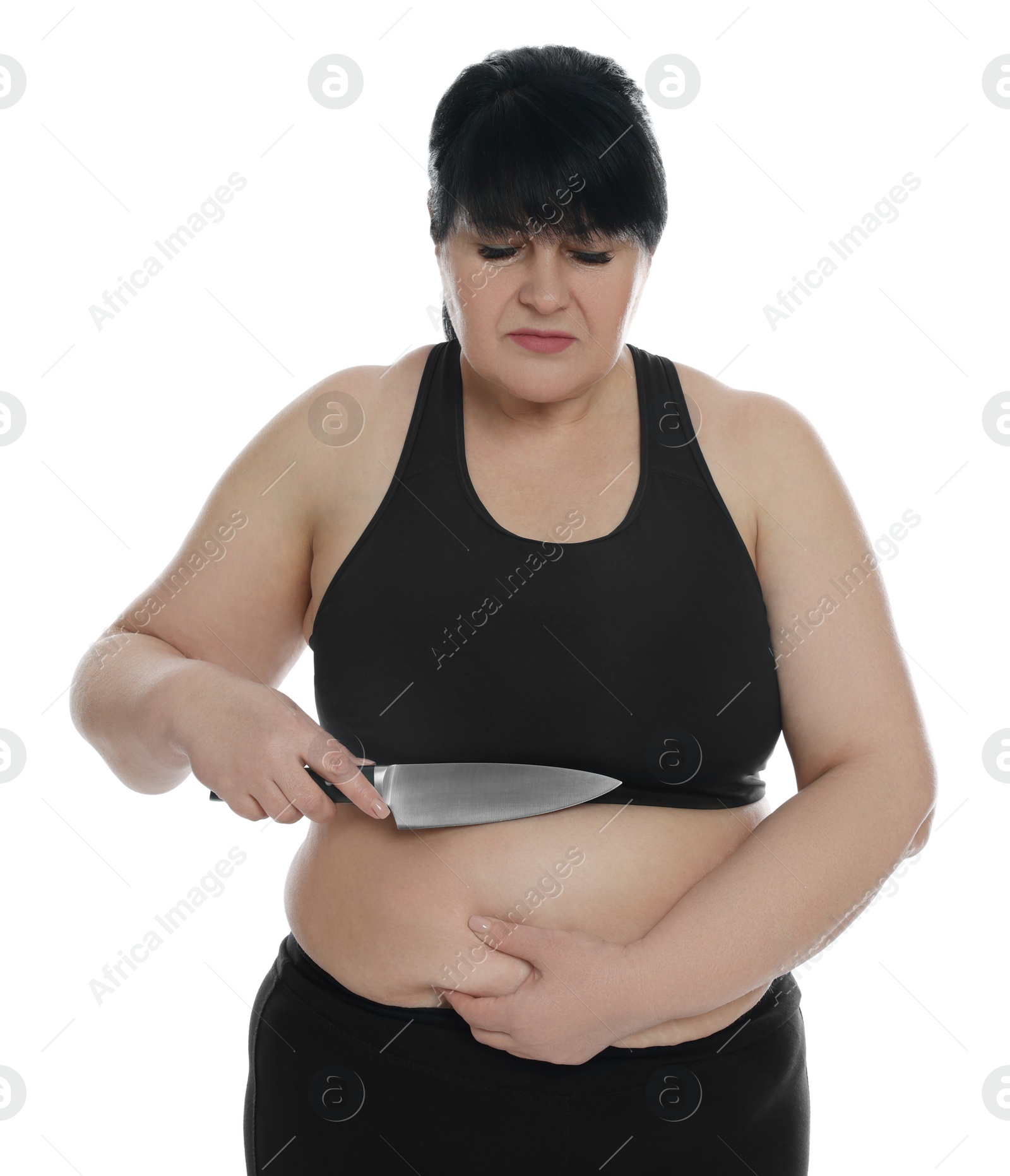 Photo of Obese woman with knife on white background. Weight loss surgery