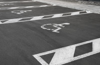 Car parking lot with wheelchair symbols outdoors