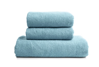 Stack of clean soft towels on white background