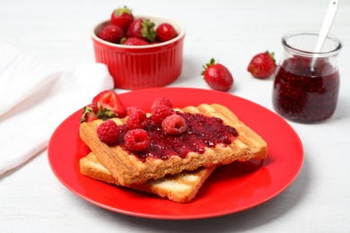 Tasty breakfast with toasts served on white wooden table