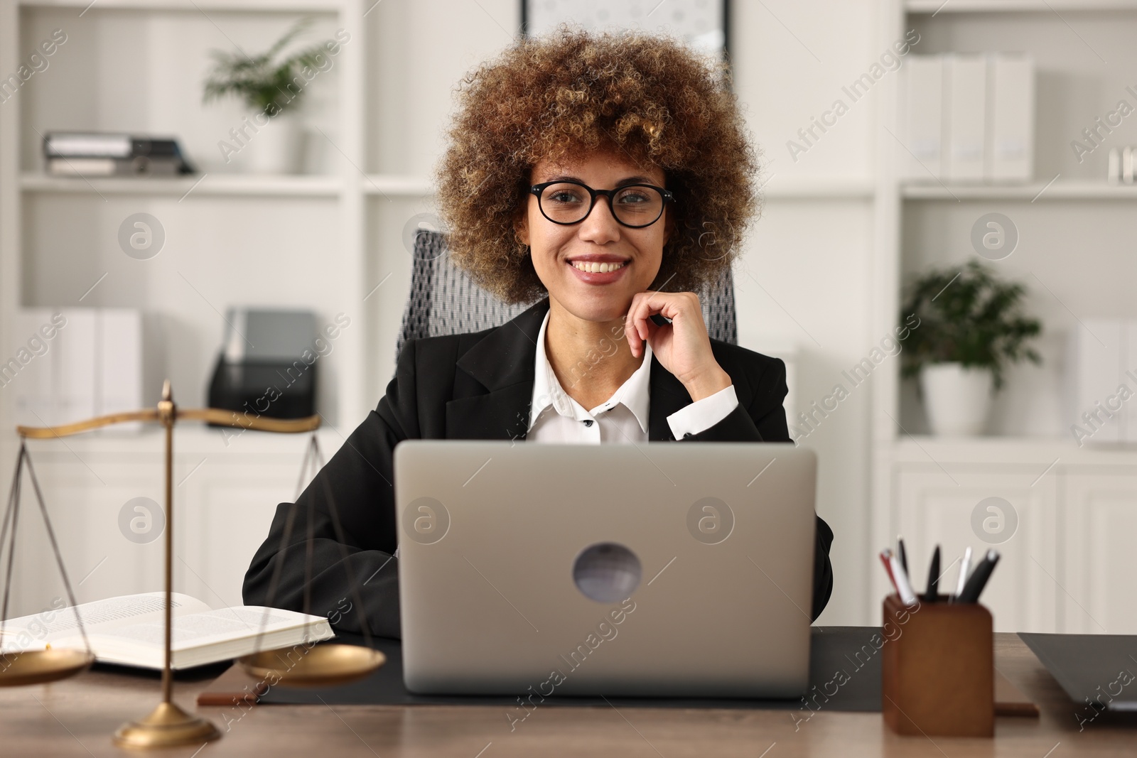 Photo of Notary using laptop at workplace in office