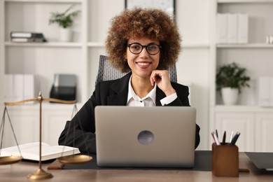 Notary using laptop at workplace in office