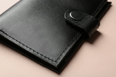 Photo of Stylish leather wallet on color background, closeup