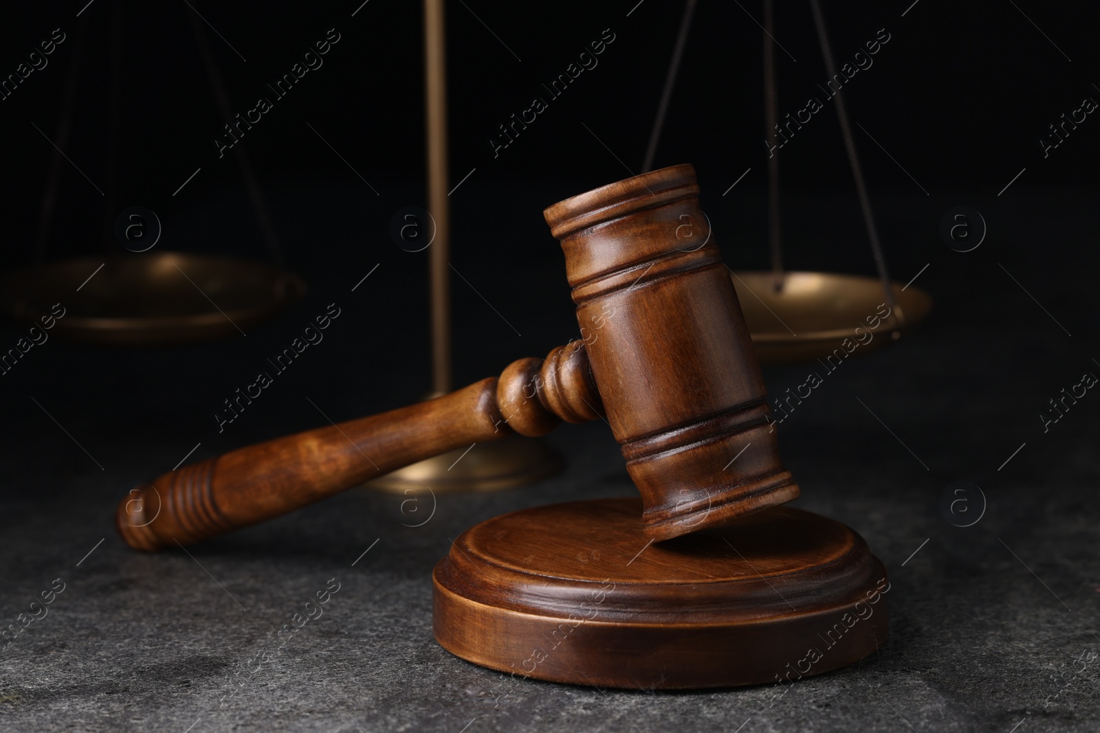 Photo of Law concept. Judge's wooden gavel on grey textured table