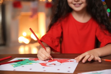 Photo of Little child drawing picture at home. Christmas celebration