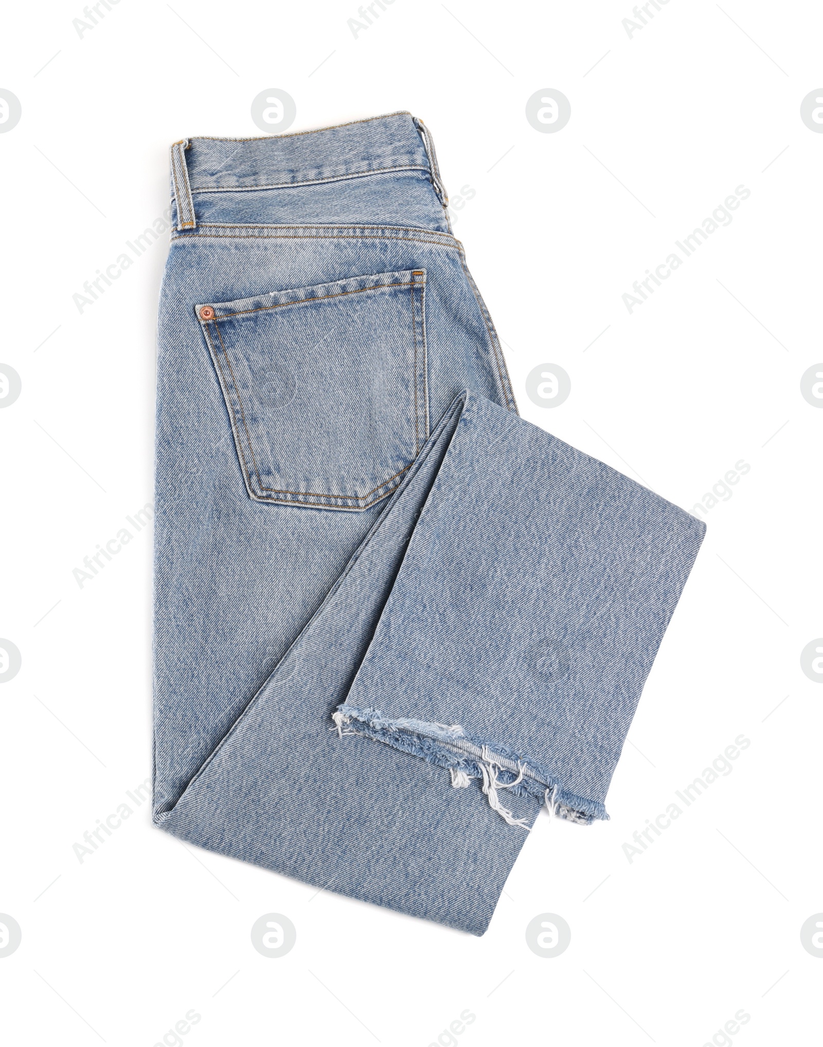 Photo of Light blue jeans isolated on white, top view. Stylish clothes