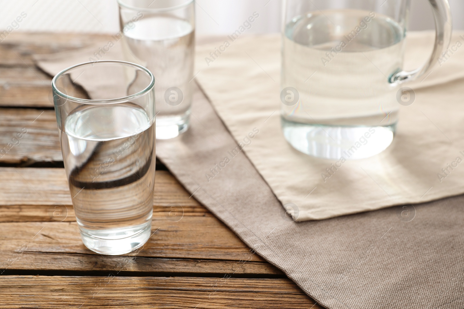 Photo of Glassware of fresh water on wooden table