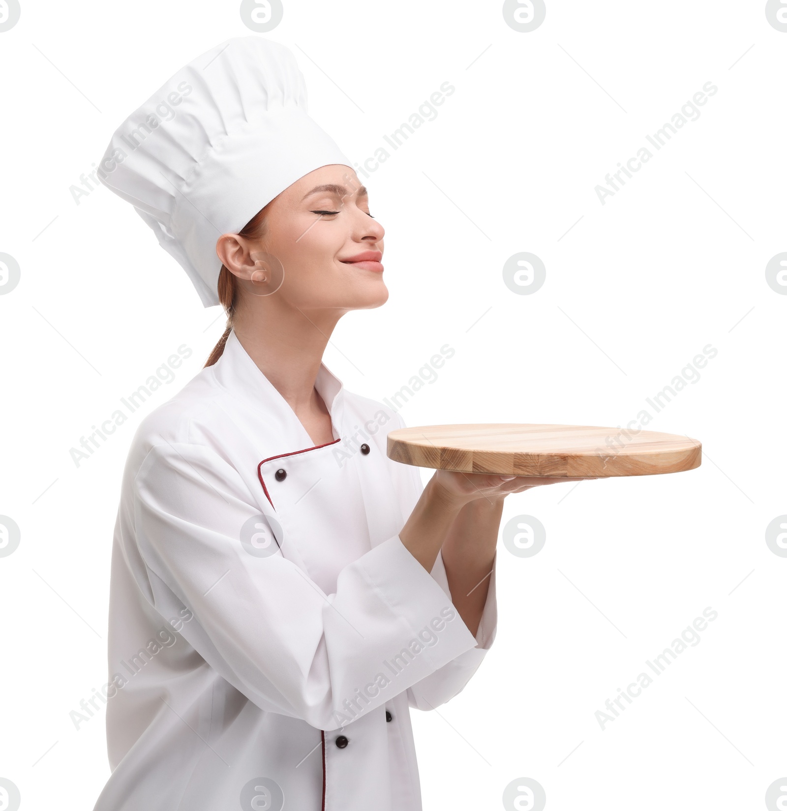 Photo of Happy chef in uniform holding empty wooden board on white background