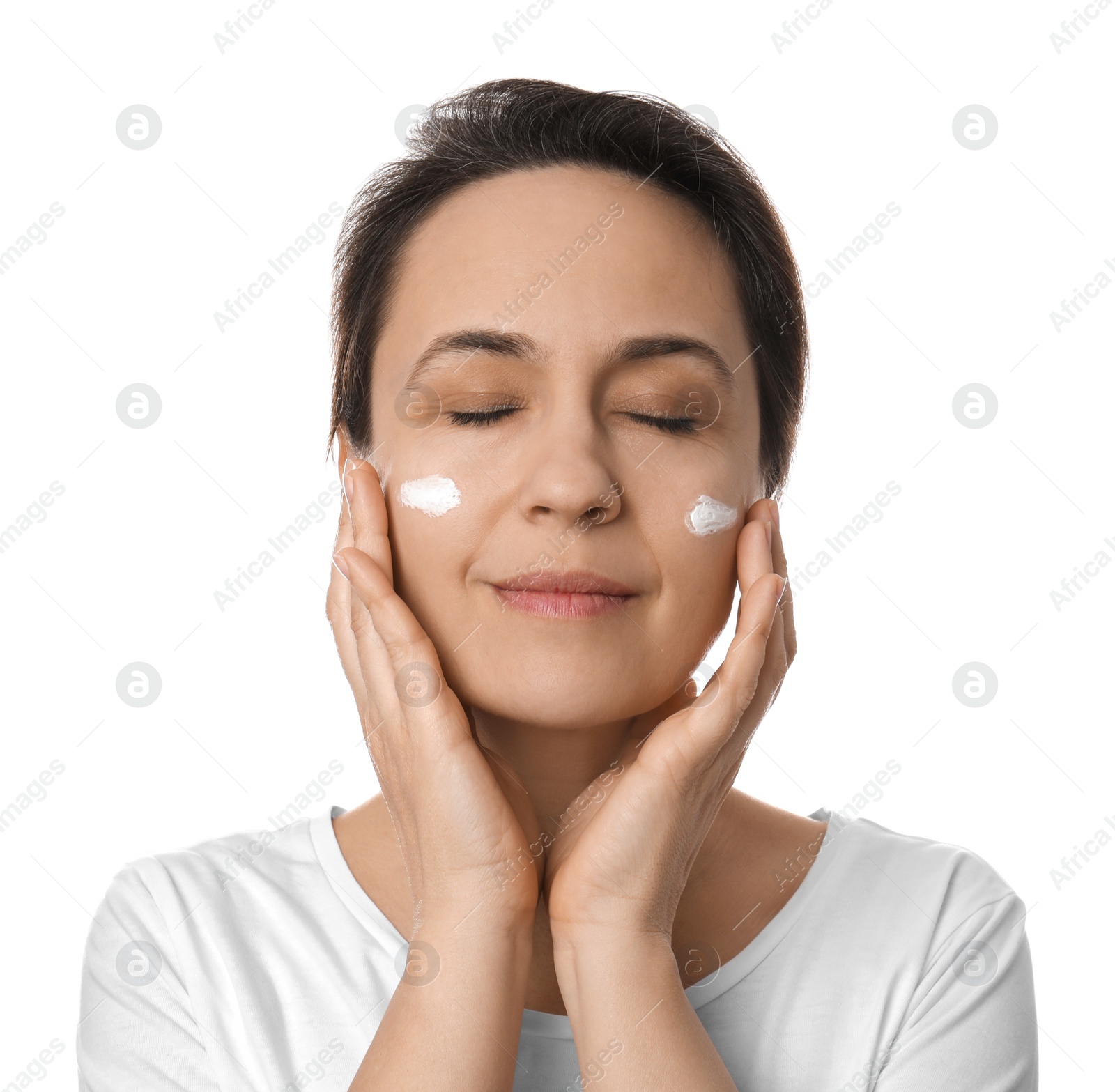 Photo of Woman applying facial cream on white background