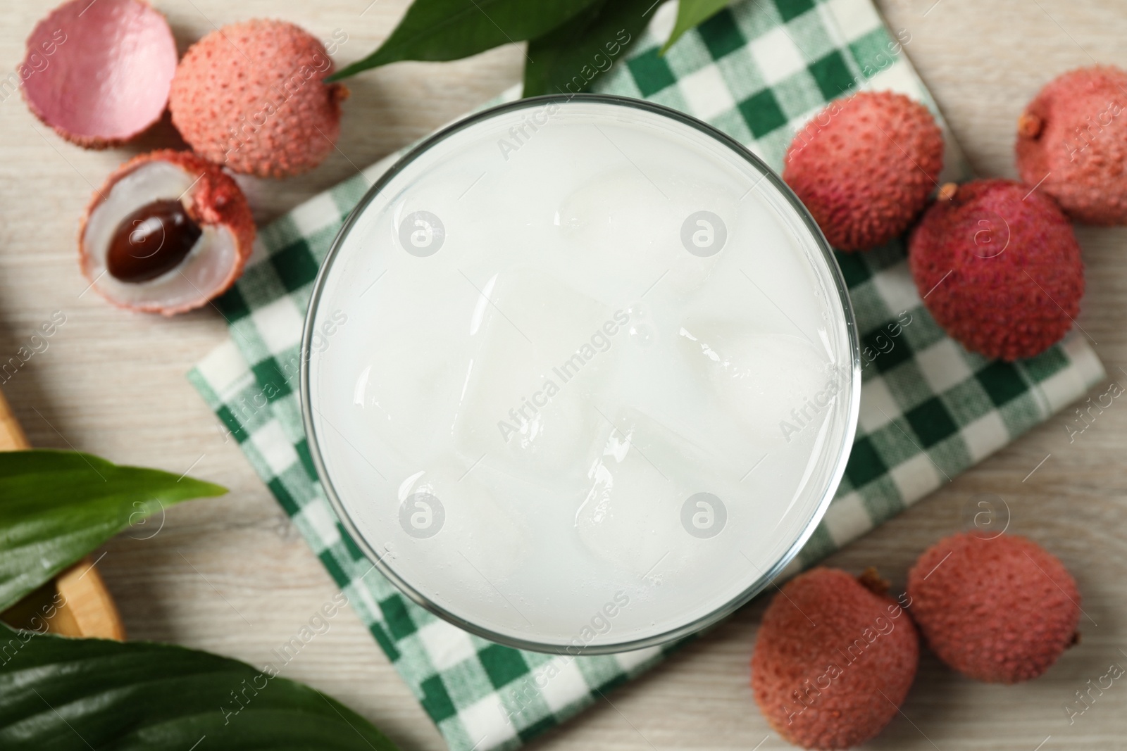 Photo of Fresh lychee juice and fruits on white wooden table, flat lay