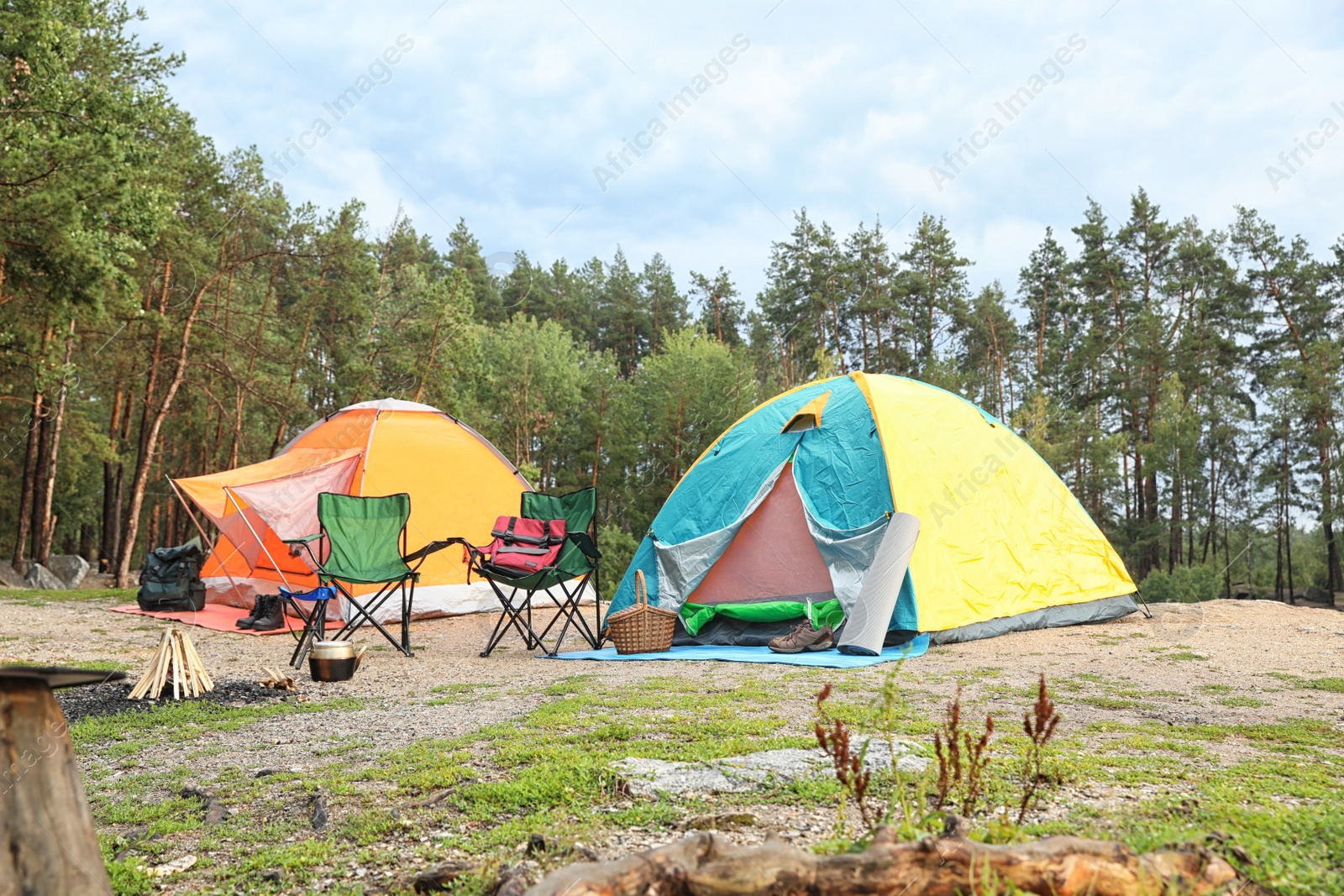 Photo of Camping tents and accessories in wilderness on summer day