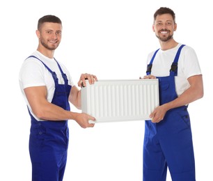 Photo of Professional plumbers with new heating radiator on white background