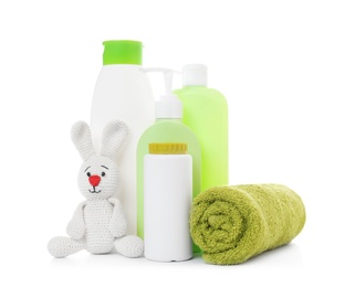 Photo of Baby cosmetic products, towel and knitted rabbit isolated on white