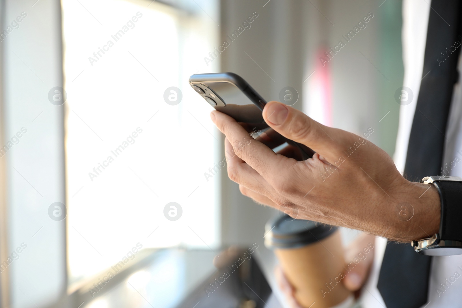 Photo of MYKOLAIV, UKRAINE - MARCH 16, 2020: Man holding iPhone 11 Black indoors, closeup