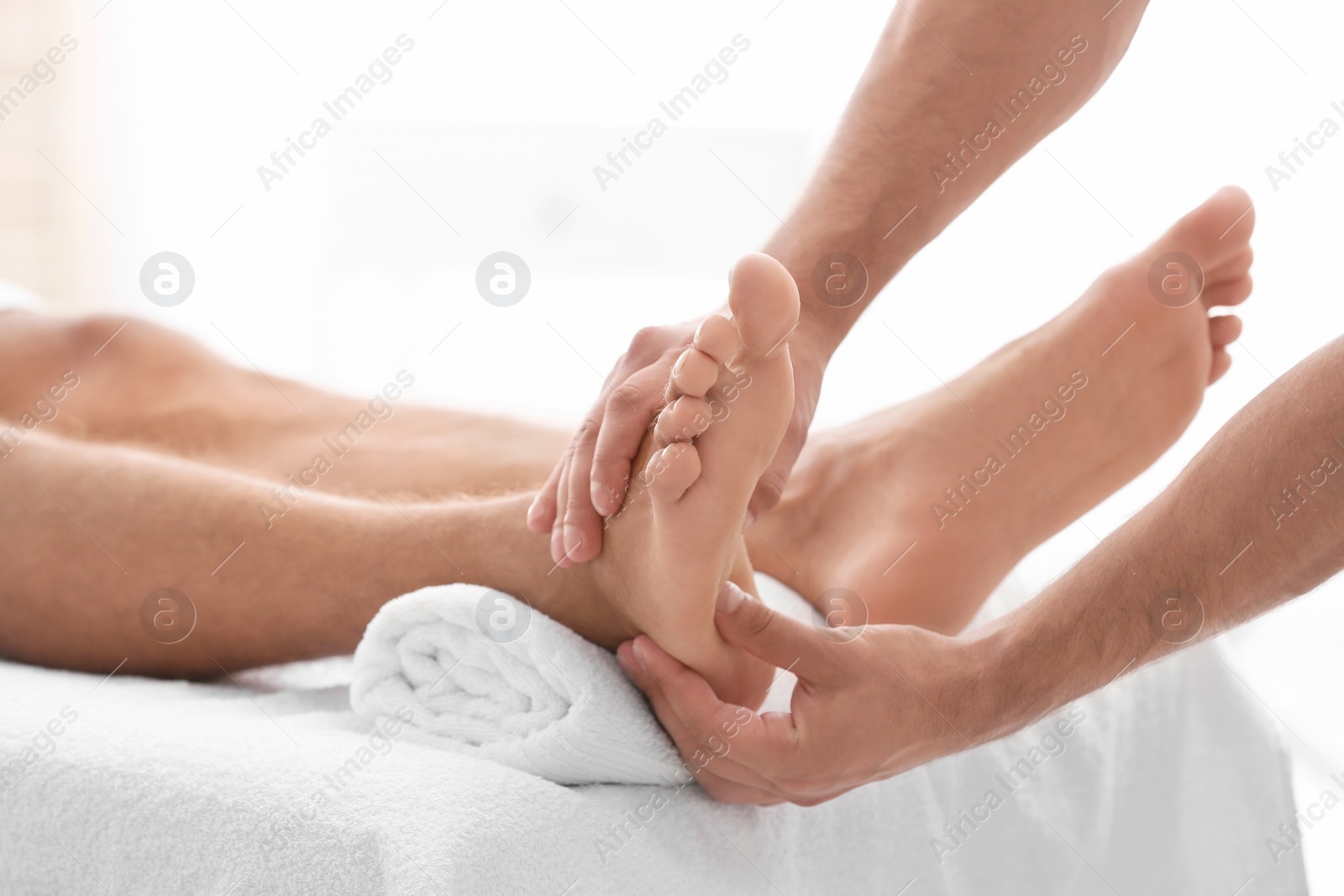 Photo of Young woman receiving massage in salon, closeup