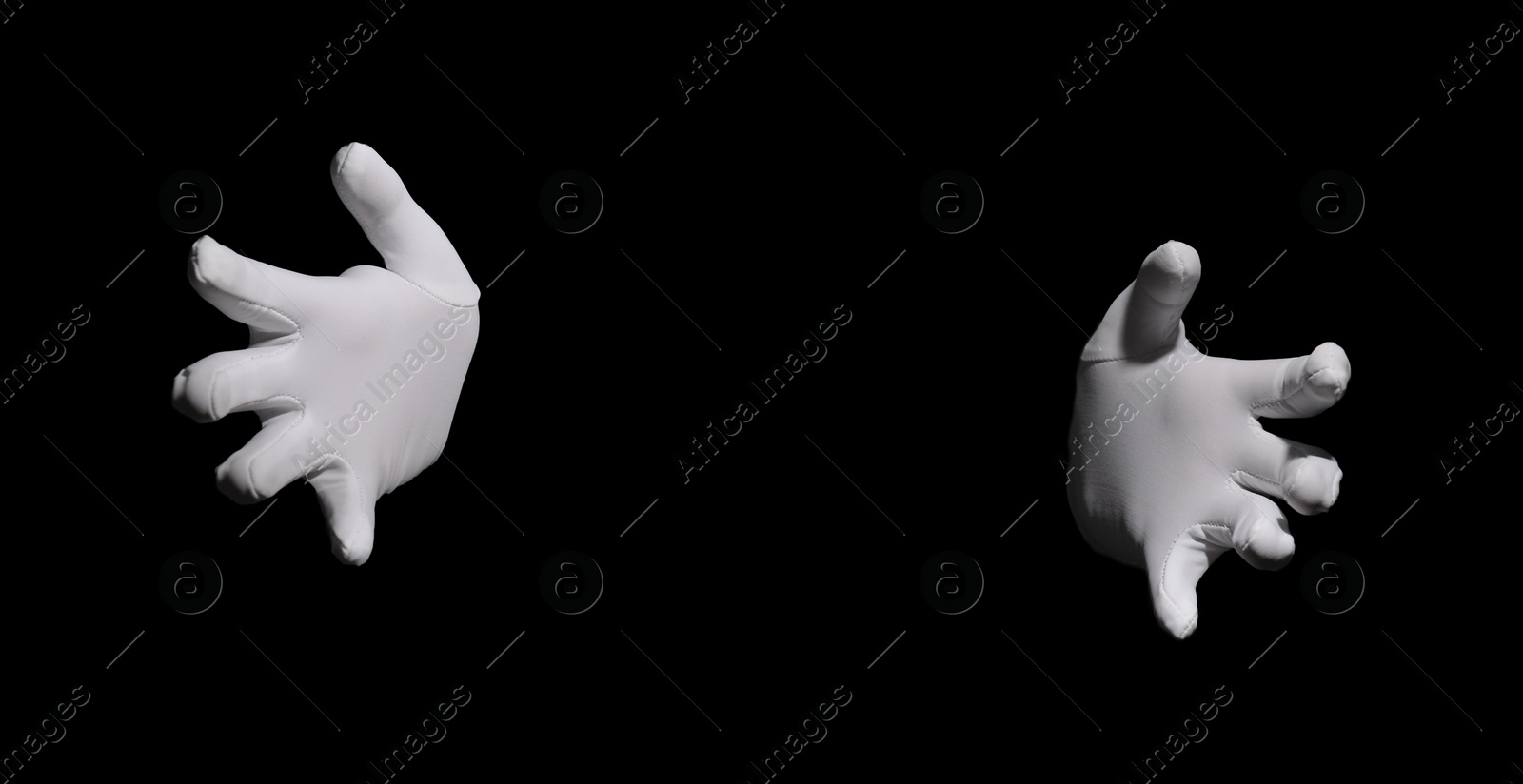 Photo of Magician holding something on black background, closeup