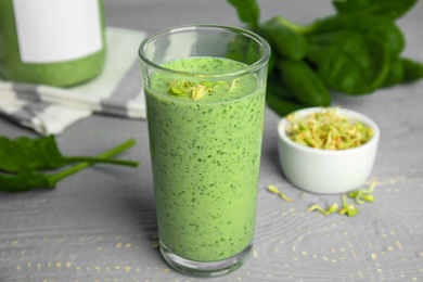 Photo of Green buckwheat smoothie on light grey wooden table