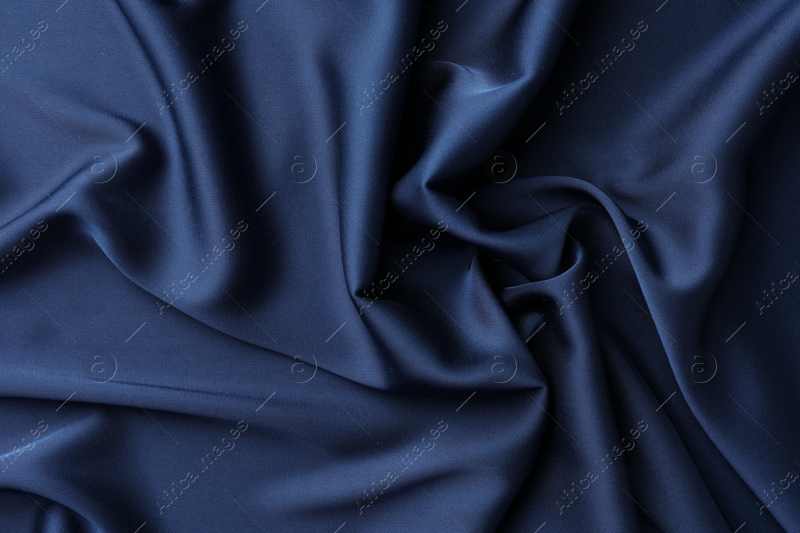 Photo of Texture of blue crumpled silk fabric as background, top view