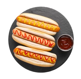 Photo of Delicious hot dogs with sauces isolated on white, top view