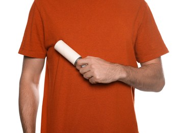 Photo of Man using lint roller on white background, closeup