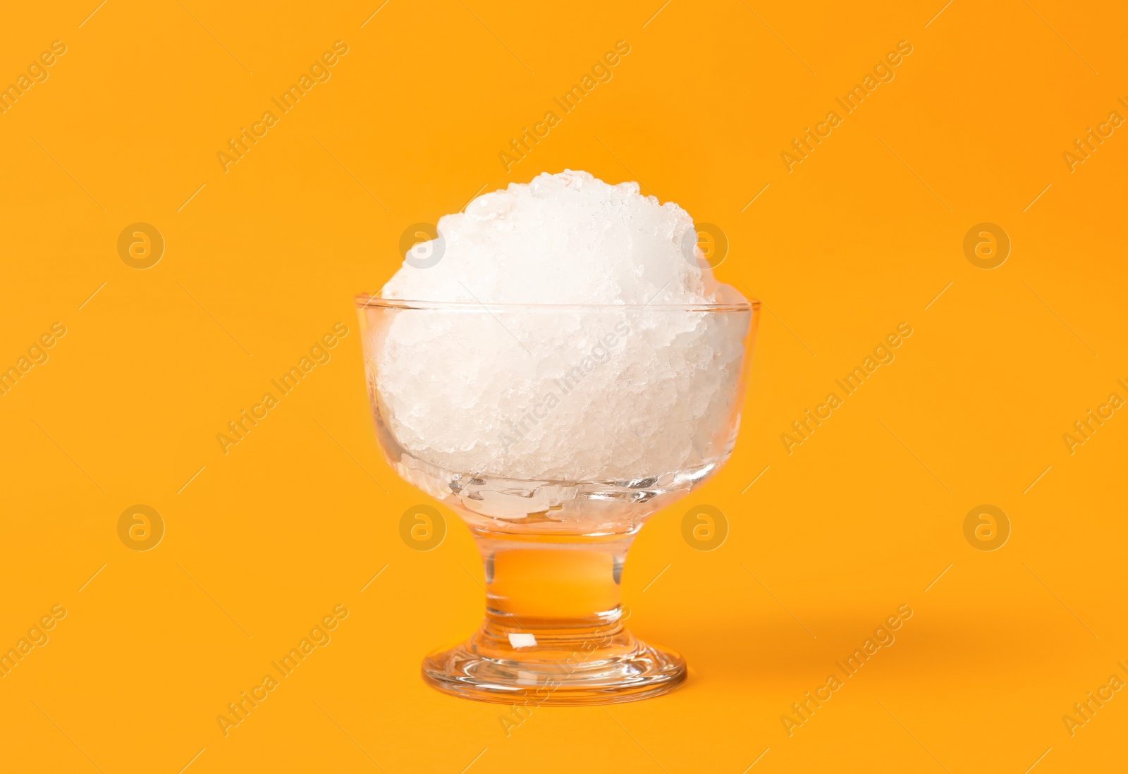 Photo of Shaving ice in glass dessert bowl on orange background