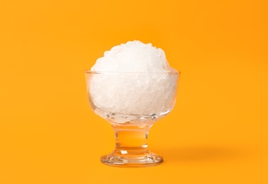 Photo of Shaving ice in glass dessert bowl on orange background