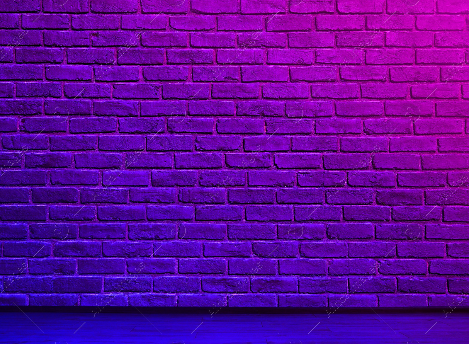 Image of Room with brick wall and wooden floor in neon lights