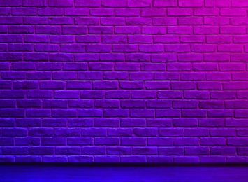 Image of Room with brick wall and wooden floor in neon lights