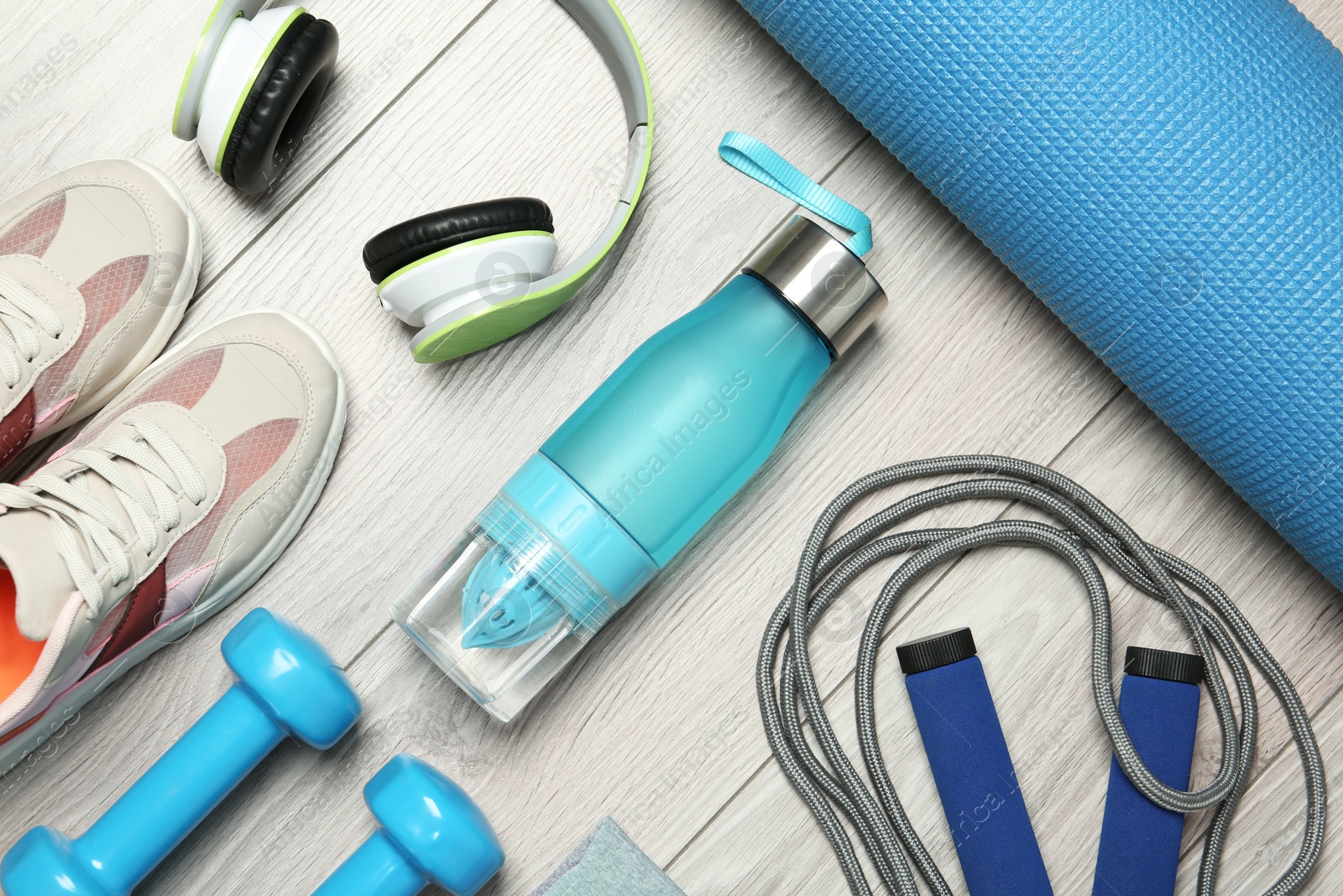 Photo of Set of fitness equipment and accessories on wooden background, flat lay