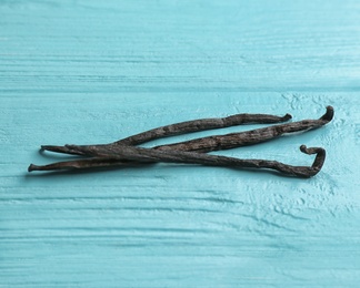 Photo of Bunch of vanilla sticks on wooden background