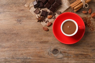 Flat lay composition with yummy hot chocolate on wooden table. Space for text