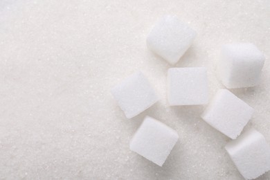 Different types of sugar as background, top view. Space for text