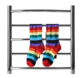 Modern heated towel rail with socks isolated on white