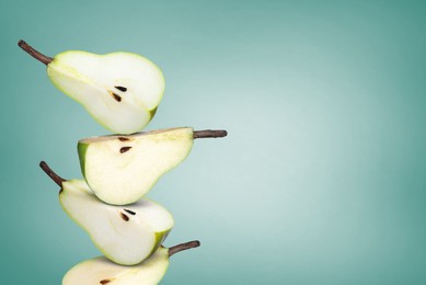 Image of Cut fresh ripe pears on teal gradient background, space for text
